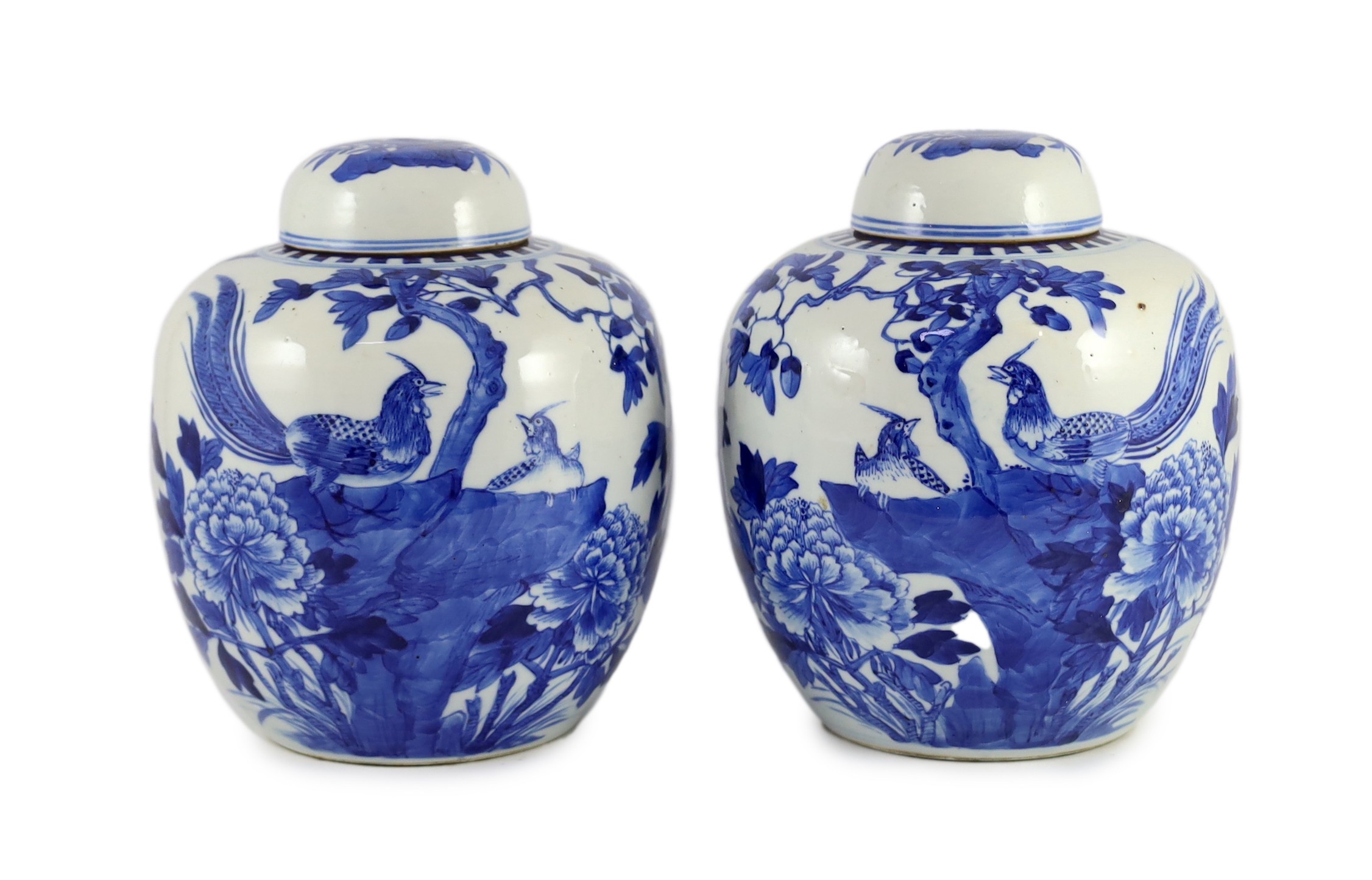 A pair of Chinese blue and white jars and covers, 19th century, 25cm high